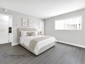 Inglewood apartment for rent - A bedroom with a large bed and a wooden floor.