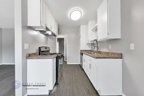 La Puente apartment for rent - A kitchen with white cabinets and a wooden floor.