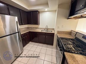 Hawthorne apartment for rent - A kitchen with a refrigerator, sink, and stove.