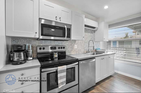 Hermosa Beach apartment for rent - a kitchen with stainless steel appliances and white cabinets