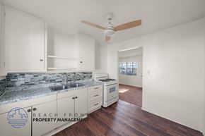 Wilmington apartment for rent - A kitchen with a marble countertop and white cabinets.