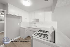 Torrance apartment for rent - A kitchen with a stove top oven and cabinets.