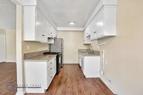 Redondo Beach apartment for rent - A kitchen with white cabinets and a granite countertop.