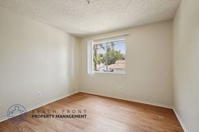 Santa Ana apartment for rent - A room with a window showing a view of a building and trees outside.