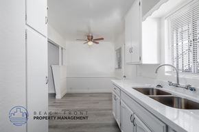 Comption apartment for rent - A kitchen with a sink, faucet, and a ceiling fan.
