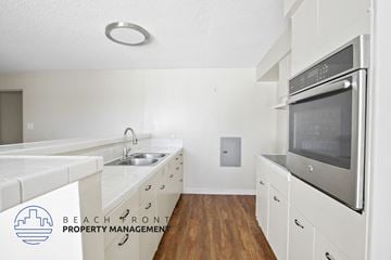Wilmington apartment for rent - A kitchen with white appliances and wooden floors.