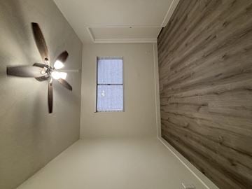 Anaheim apartment for rent - A room with a ceiling fan and a window.
