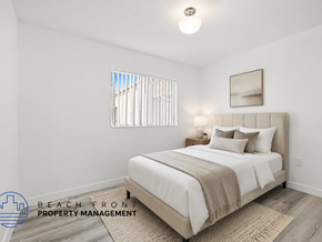 Van Nuys apartment for rent - A bedroom with a bed, nightstand, and window with blinds.