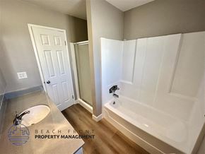 Redondo Beach apartment for rent - a bathroom with a white tub and a sink and a mirror