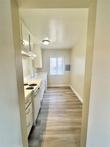 La Habra apartment for rent - A kitchen with white cabinets and a window.