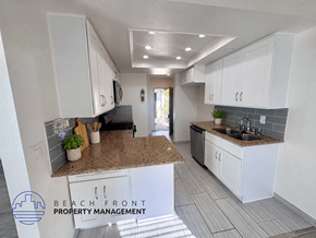Los Angeles apartment for rent - A kitchen with white cabinets and a granite countertop.