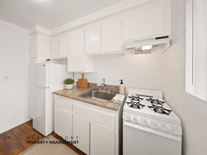 Hawthorne apartment for rent - A kitchen with a white stove, sink, and cabinets.
