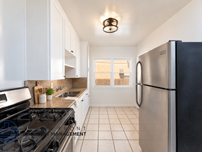 Long Beach apartment for rent - A kitchen with a black stove top oven and a black refrigerator.