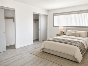 Huntington Beach apartment for rent - A bedroom with a bed, nightstand, and two closets.