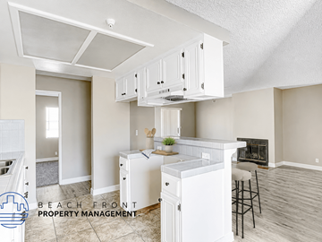 Hawthorne apartment for rent - A kitchen with white cabinets and a stove top oven.