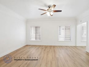 Long Beach apartment for rent - A room with a ceiling fan and wooden flooring.