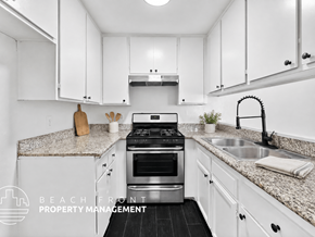 Los Angeles apartment for rent - A modern kitchen with white cabinets and a granite countertop.