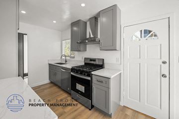 Santa Monica apartment for rent - A modern kitchen with a stove top oven and a white door.