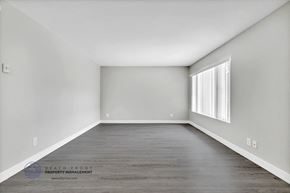 Inglewood apartment for rent - an empty room with gray walls and a large window