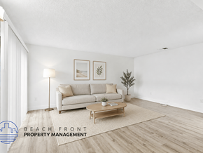 Anaheim apartment for rent - A living room with a couch, a coffee table, and a plant.