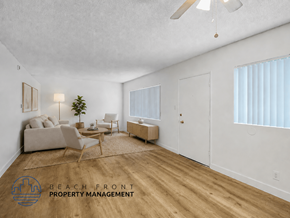Inglewood apartment for rent - A living room with a couch, chairs, and a ceiling fan.