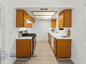 Inglewood townhouse for rent - A kitchen with wooden cabinets and a white countertop.