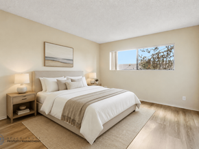 Hawthorne apartment for rent - A well-lit bedroom with a large bed and a painting on the wall.