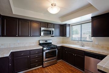 La Habra apartment for rent - a kitchen with a stove and a sink and a microwave