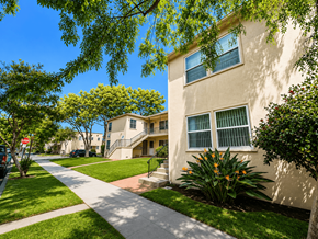 Long Beach apartment for rent - A sunny day in a quiet residential street with apartment buildings on either side.