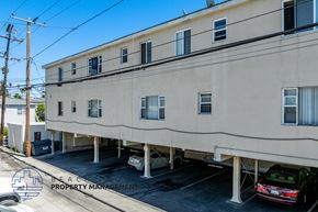 Long Beach apartment for rent - A building with a parking lot in front of it.