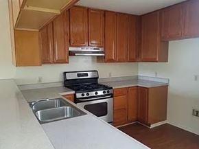 Harbor City apartment for rent - A kitchen with a stove, sink, and cabinets.