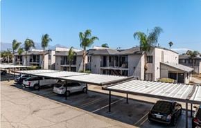 Pomona apartment for rent - A parking lot with cars and a building in the background.