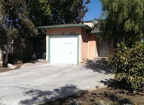 Harbor City apartment for rent - A garage with the number 1533 on it is surrounded by trees and bushes.