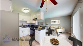 Downey apartment for rent - A kitchen with a fan and a dining table with chairs.