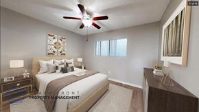 Downey apartment for rent - A bedroom with a bed, nightstand, and a ceiling fan.