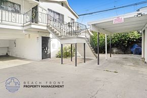 Huntington Park apartment for rent - A white building with a balcony and a sign that says "No Driving Allowed".