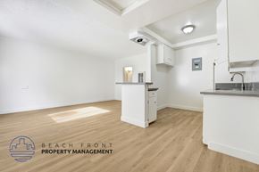Huntington Park apartment for rent - A kitchen area with a logo of Beach Front Property Management.