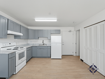 Honolulu apartment for rent - A kitchen with a white stove top oven and a white refrigerator.