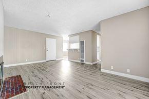 Wilmington apartment for rent - A spacious room with wooden flooring and a rug on the floor.