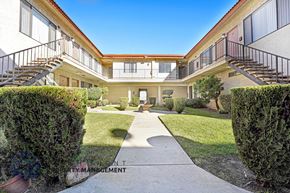 Hawthorne apartment for rent - A courtyard surrounded by buildings with a clear blue sky.