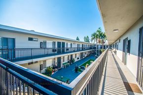 Downey apartment for rent - a view of a building with a pool and balconies