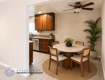 Downey apartment for rent - A dining room with a round table and chairs, a ceiling fan, and a kitchen area in the background.