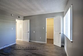 Garden Grove apartment for rent - A room with a white door and a window on the right side.