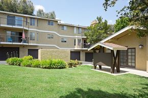 La Habra apartment for rent - an apartment building with a yard and a picnic table