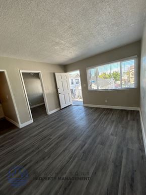 Long Beach apartment for rent - an empty living room with hardwood floors and a window