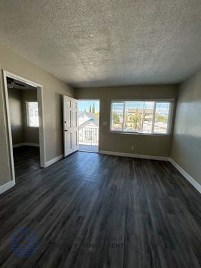 Long Beach apartment for rent - an empty living room with wood floors and a window
