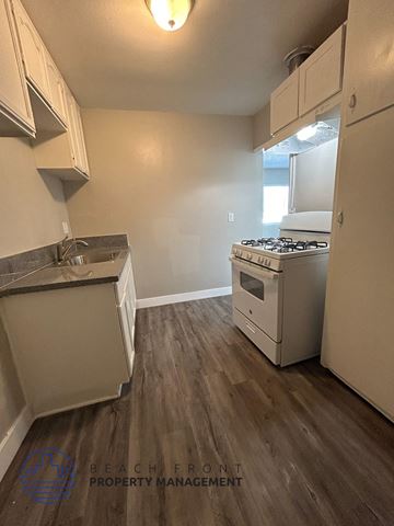 Long Beach apartment for rent - A kitchen with a stove and a refrigerator.
