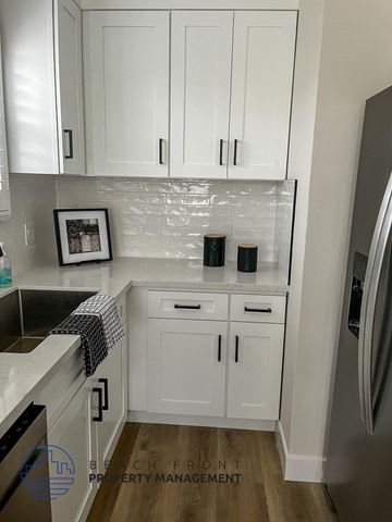 Hermosa Beach apartment for rent - A kitchen with white cabinets and a fridge.