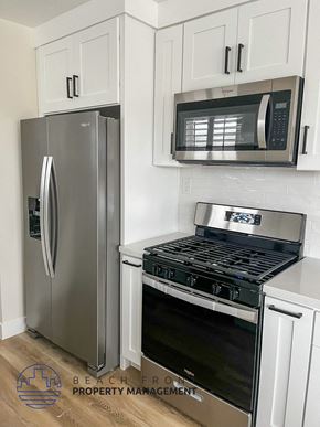 Hermosa Beach apartment for rent - a white kitchen with stainless steel appliances and a refrigerator