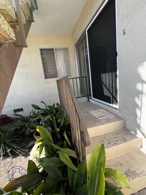 Torrance apartment for rent - A balcony with a railing and steps leading up to a glass door.